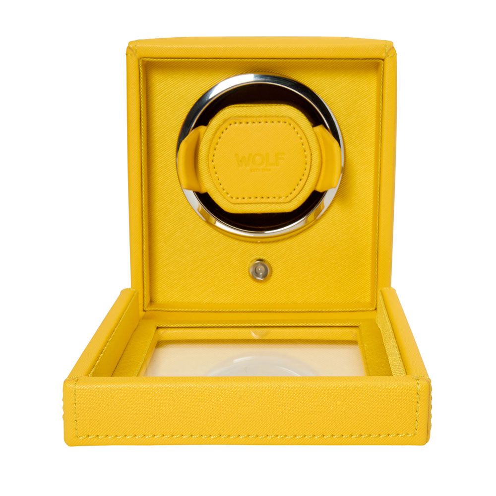 The WOLF 1834 Cub Single Watch Winder in yellow vegan leather features a glass lid panel, textured finish, circular holder labeled "WOLF," and patented rotation programs.