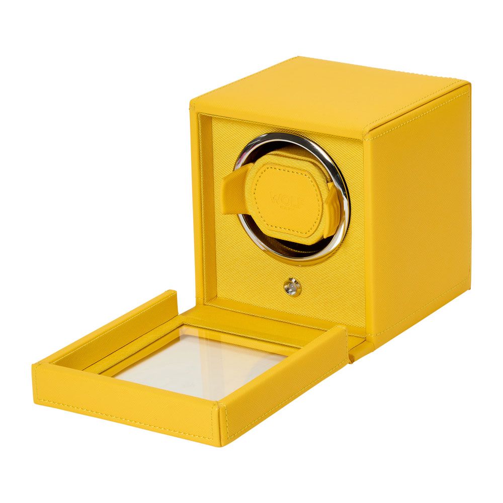 The WOLF 1834 Cub Single Watch Winder Yellow by WOLF features a front glass lid, circular watch holder, and textured vegan leather finish. Its modern design includes patented rotation programs for optimal watch care.