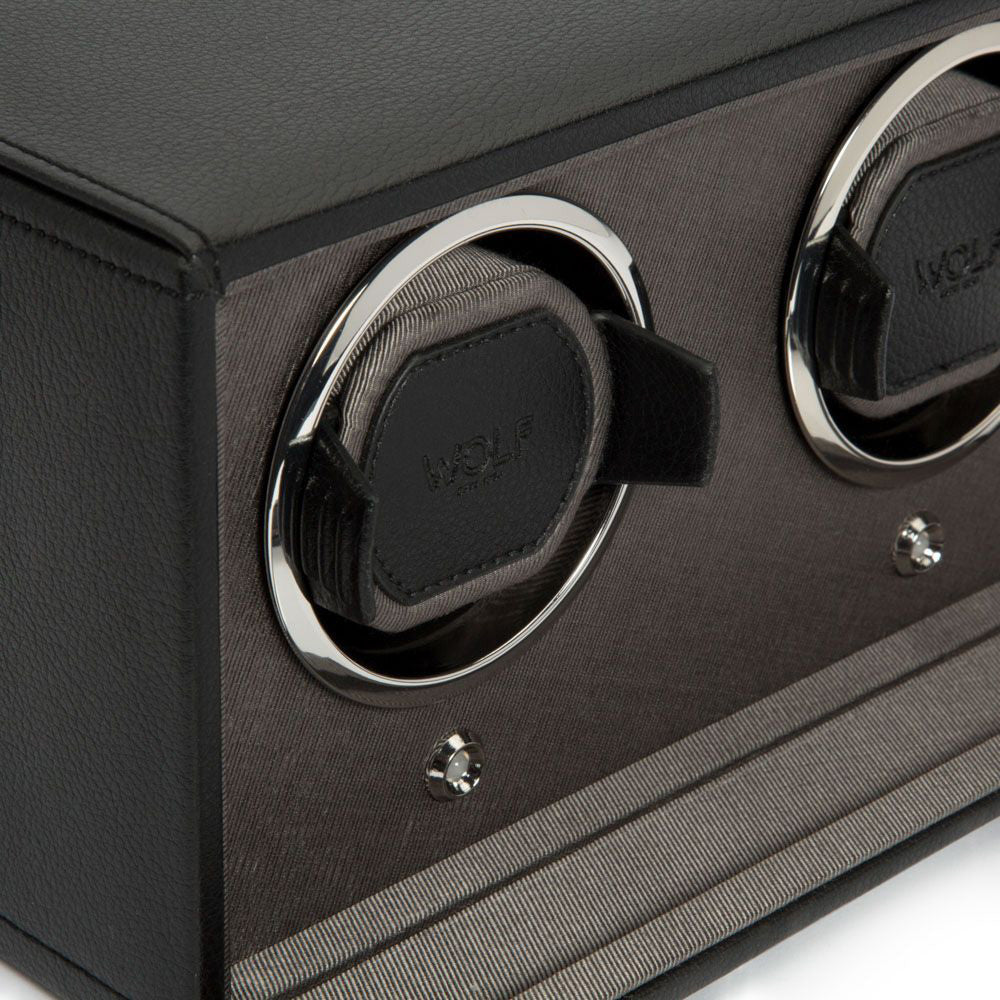 Close-up of the WOLF 1834 Cub Double Watch Winder With Cover, showcasing two padded slots with patented lock-in cuffs for securely holding watches. Its textured surface is crafted from vegan leather and enhanced with chrome accents, offering a sleek and modern appearance.