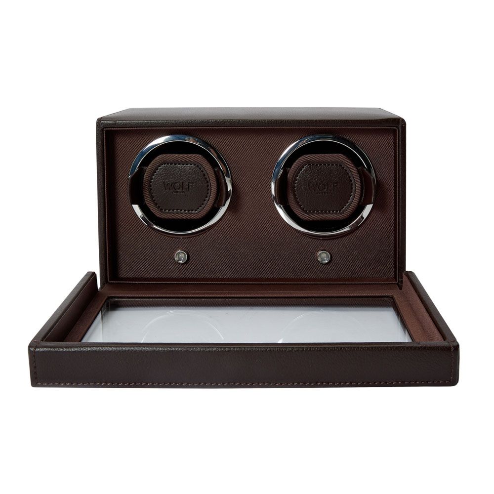 The WOLF 1834 Cub Double Winder With Cover Brown by WOLF is a sophisticated brown vegan leather watch winder box showcasing two circular watch holders and a glass display cover, opening to reveal a meticulously crafted interior with customizable rotation programs.