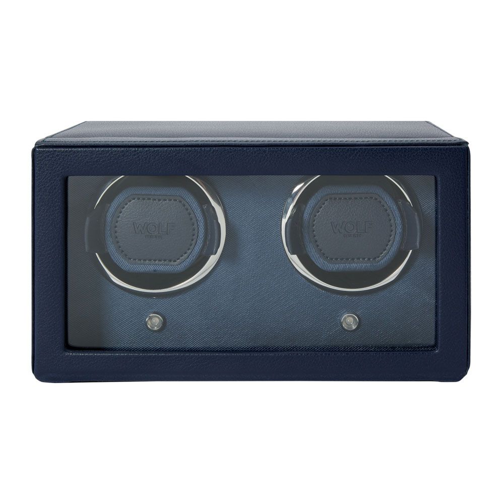 The WOLF 1834 Cub Double Winder With Cover in Navy is a rectangular watch winder from WOLF, crafted from premium vegan leather in navy blue, featuring a glass front and housing two watch slots inside with patented rotation technology.
