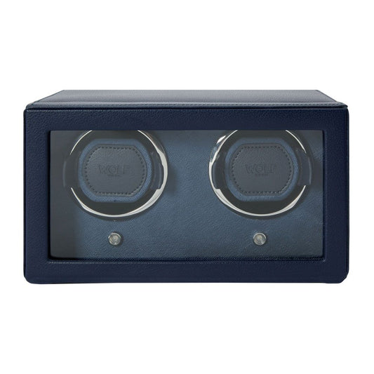 The WOLF 1834 Cub Double Winder With Cover in Navy is a rectangular watch winder from WOLF, crafted from premium vegan leather in navy blue, featuring a glass front and housing two watch slots inside with patented rotation technology.