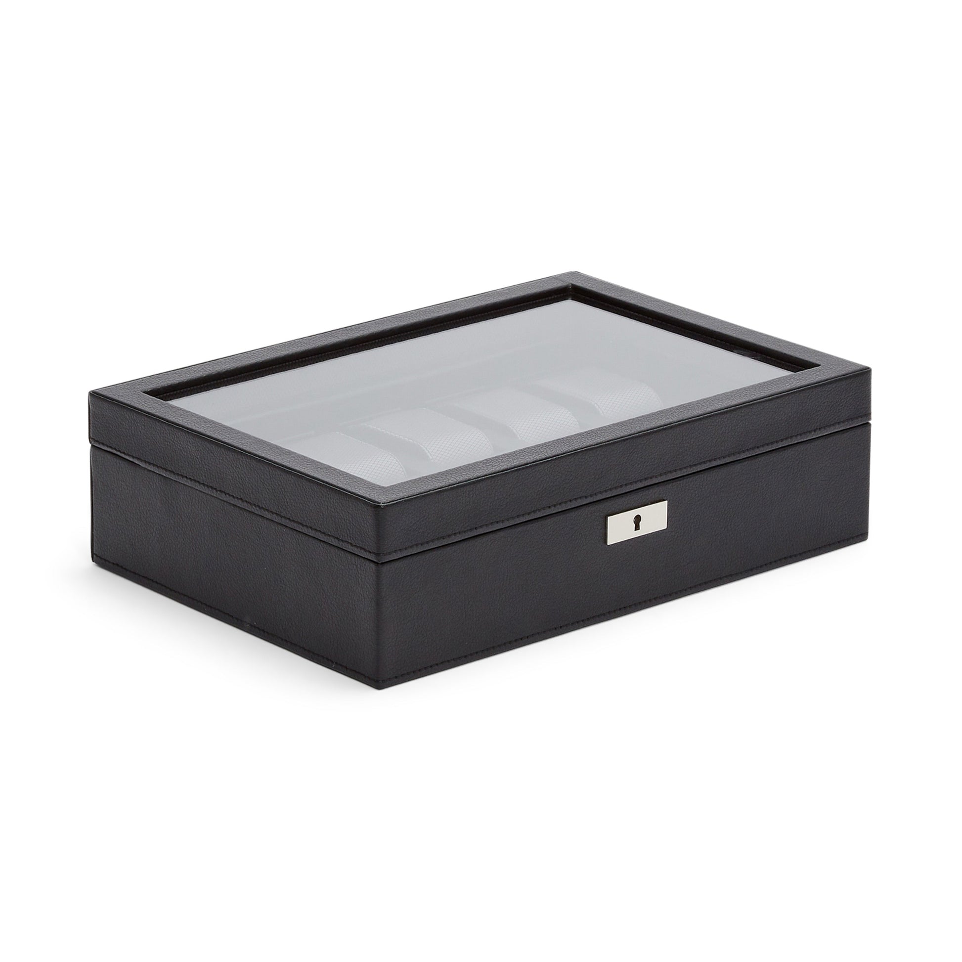 The WOLF 1834 10 Piece Watch Box, from the renowned brand WOLF, is a black rectangular piece made from vegan leather. It boasts a glass top and features a metal lock at the front for added security. Inside, you’ll find ample watch storage with compartments that are easily visible through its transparent lid. This sophisticated box is elegantly displayed on a pristine white surface.