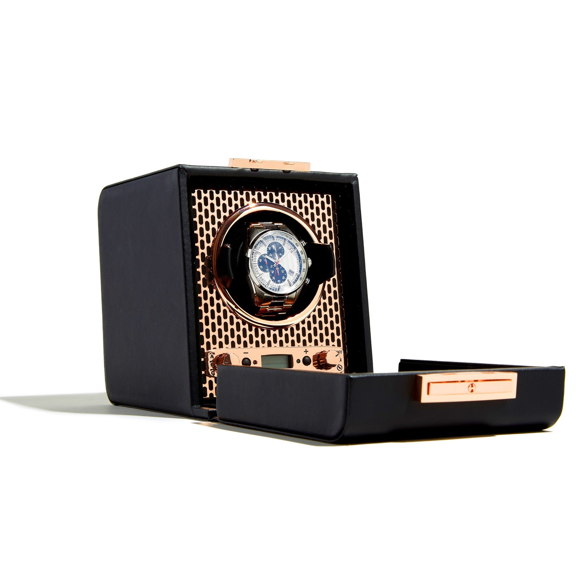 On display is the WOLF 1834 Axis Single Watch Winder, a luxury accessory featuring a sleek black exterior with elegant copper accents. The open winder reveals a watch boasting a round face with multiple dials, comfortably set within its distinctive honeycomb-patterned interior. Designed with several rotation options, it ensures your timepiece remains in perfect sync.