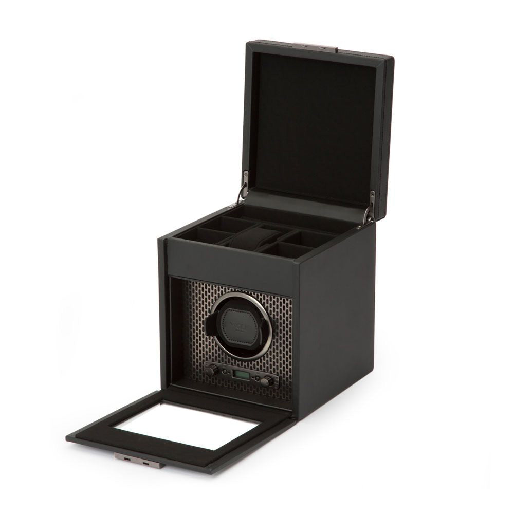 A black WOLF 1834 Axis Single Watch Winder with Storage features an open box design with compartments, displaying a visible dial and the signature WOLF winder. The front panel is open, highlighting a mesh-like pattern and part of its mechanical device, which is enhanced by rotation options for optimal functionality.