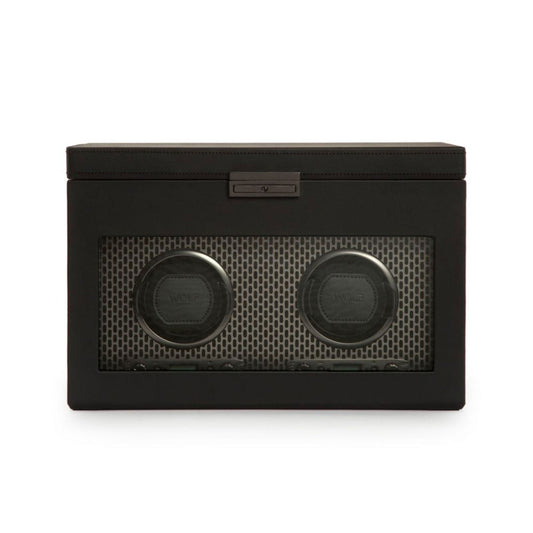 The WOLF 1834 Axis Double Winder With Storage is a stylish, black rectangular watch storage box with a glass front that showcases two round winding modules inside. The holders are set against a textured, powder-coated steel backdrop, which enhances the modern design.