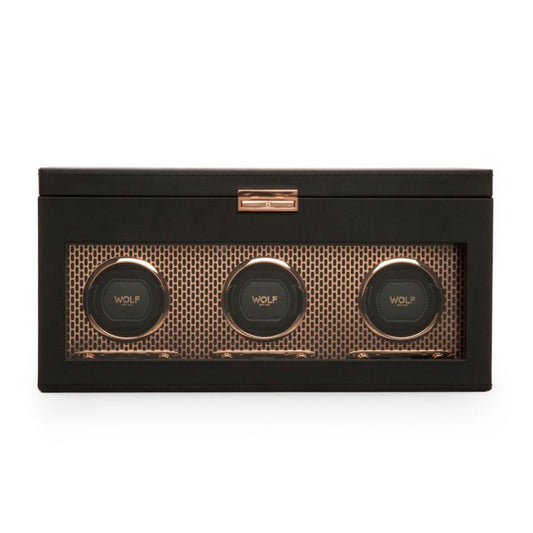 The WOLF 1834 Axis Watch Winder, designed by the brand WOLF, is a black leather accessory that includes three circular compartments with a transparent front panel. Inside, the micro suede interior showcases a gold hexagonal pattern, adding to the elegance of this luxurious watch storage solution where "WOLF" is prominently displayed on each winding module.