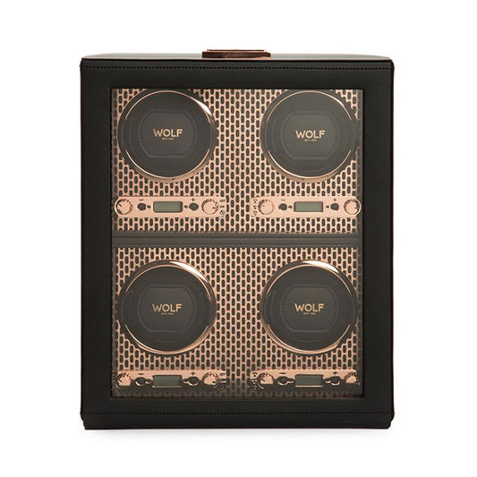 The WOLF 1834 Axis 4 Piece Winder features a sleek black and gold design, with four circular slots labeled "WOLF" for securing timepieces. Each slot is set against an elegant gold-patterned background within a rectangular black case.
