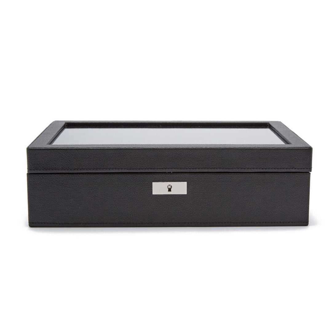 The WOLF 1834 Roadster 10 Piece Watch Box from WOLF is a sleek black vegan leather storage solution, featuring a glass lid and a metal keyhole on the front, perfect for stylishly storing and displaying your watches.