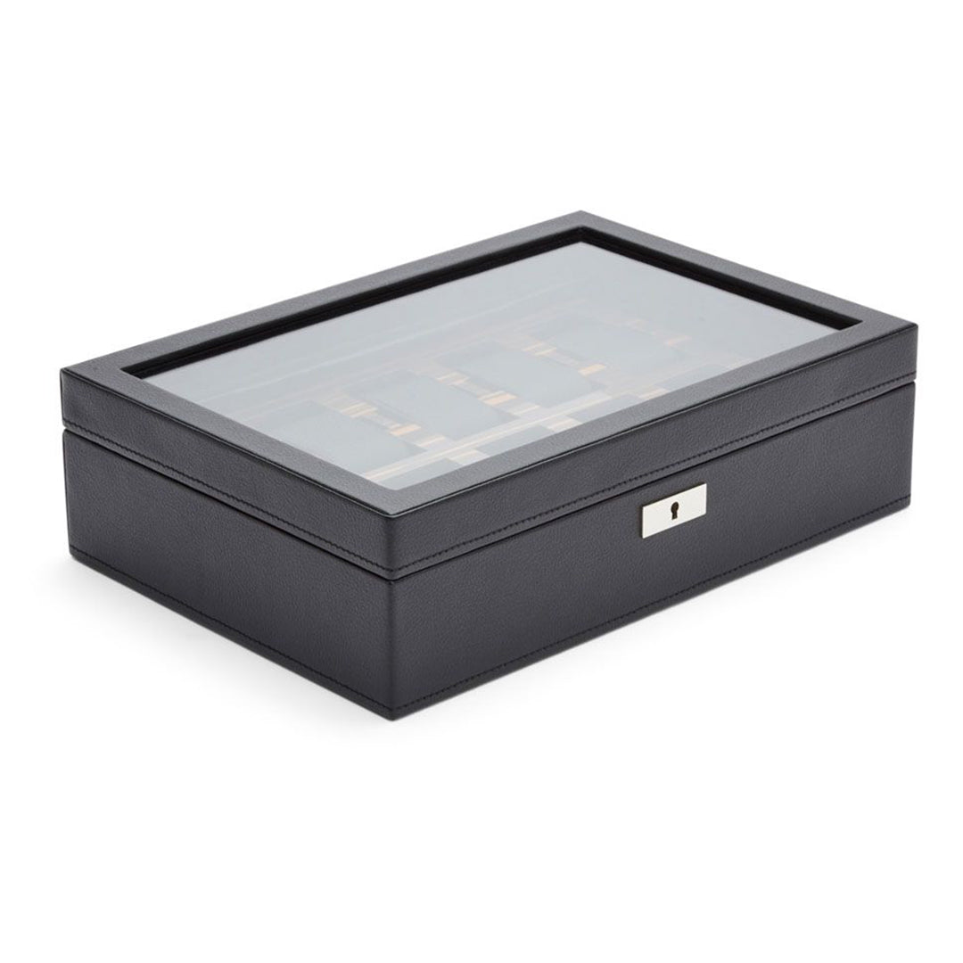 The WOLF 1834 Roadster 10 Piece Watch Box, crafted by WOLF, is a sophisticated black vegan leather accessory complete with a glass top and a silver lock in front. Designed for both storage and display, it offers an elegant and modern look with ample space to organize multiple watches stylishly.
