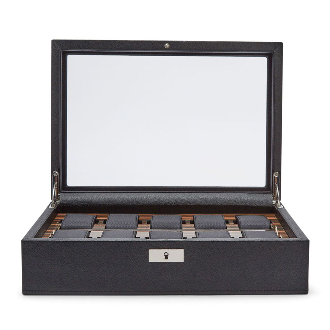 The WOLF 1834 Roadster 10 Piece Watch Box showcases a sophisticated design with a glass lid and is crafted from vegan leather. It opens to reveal multiple compartments lined with soft material, perfect for organizing and displaying your watches, while a keyhole at the front ensures secure storage.