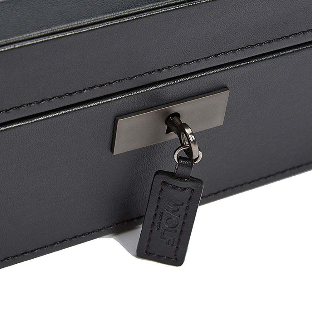 A detailed view of the WOLF 1834 Axis 10 Piece Watch Box, crafted in black leather with a metal locking mechanism for securing watches. A small key with a black leather tag featuring the "WOLF" brand name is inserted into the lock, highlighting its lock and key security feature. The intricate stitching on the leather is prominently visible.