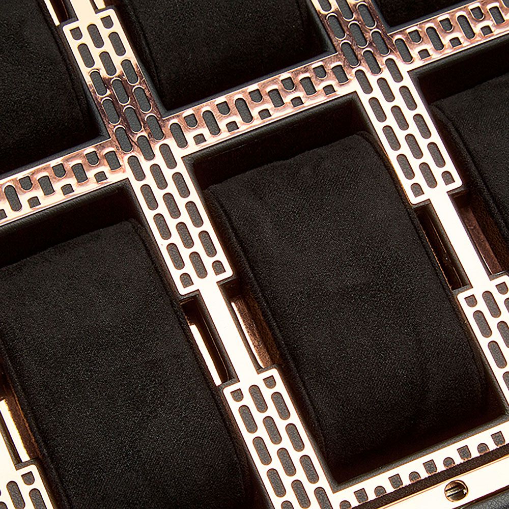 Close-up of the WOLF 1834 Axis 10 Piece Watch Box With Drawer by WOLF, featuring a sophisticated metallic frame and black cushioned compartments—ideal for elegant watch storage with enhanced lock and key security.