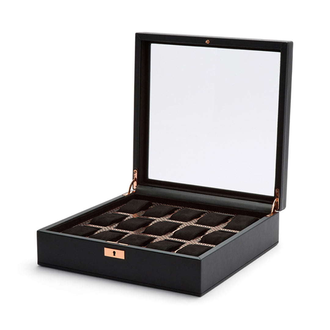 The WOLF 1834 Axis 15 Piece Watch Box from WOLF features a transparent glass lid, highlighting its compartments lined with dark fabric for your watch collection. Equipped with lock and key security on the front, this elegant box keeps your watches safe and stylishly displayed.