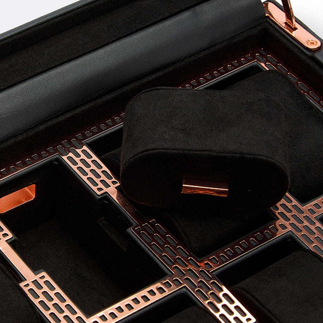 Close-up of the WOLF 1834 Axis 15 Piece Watch Box, a black and copper storage case featuring lock and key security and a removable black cushion. Designed with a grid pattern of rectangular compartments, it is ideal for organizing and displaying watches while ensuring both style and safety for your collection.