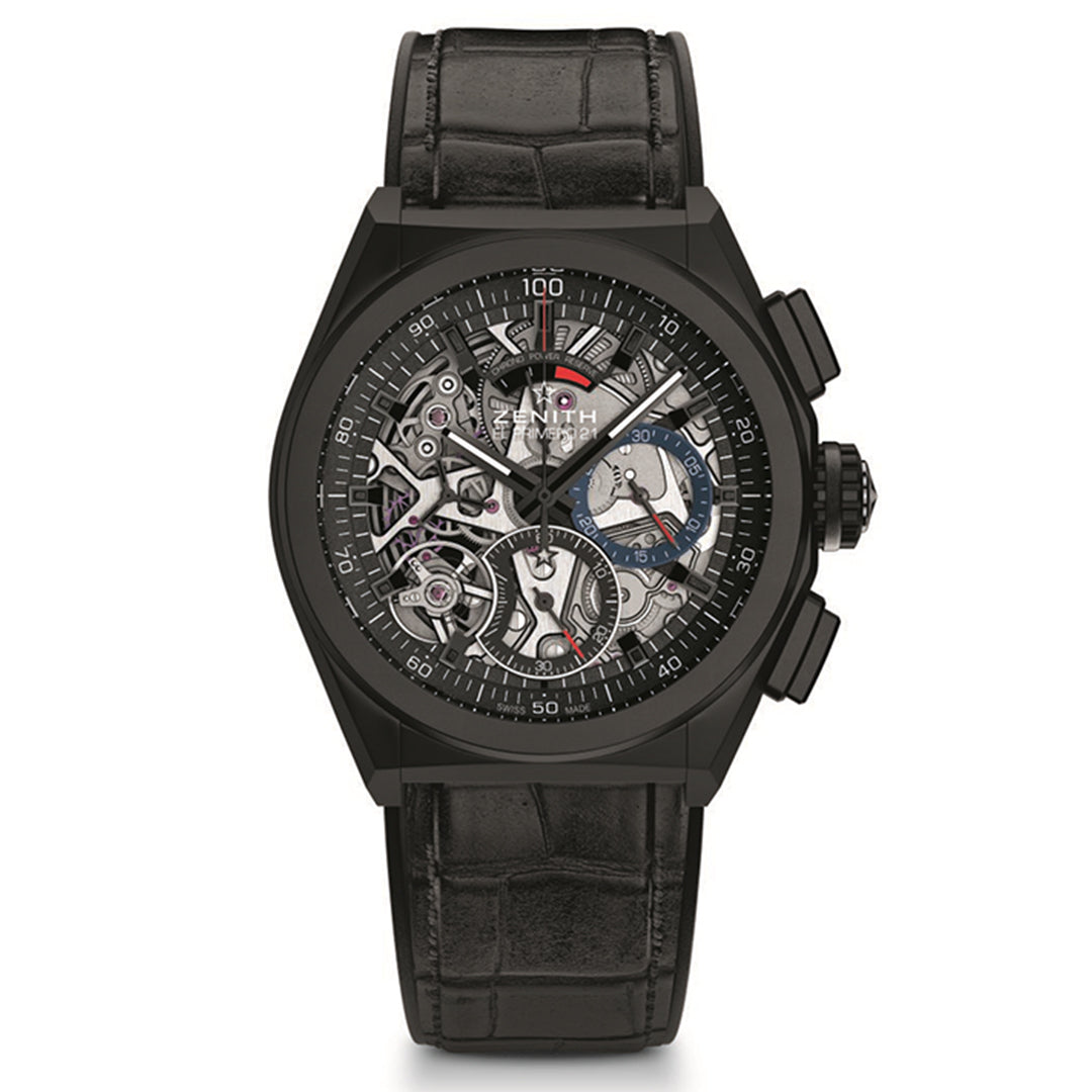 The ZENITH Defy El Primero 21 is a luxury watch featuring a detailed skeleton dial and intricate mechanics. It boasts a black crocodile-pattern leather strap, metal hands, and chronograph features.