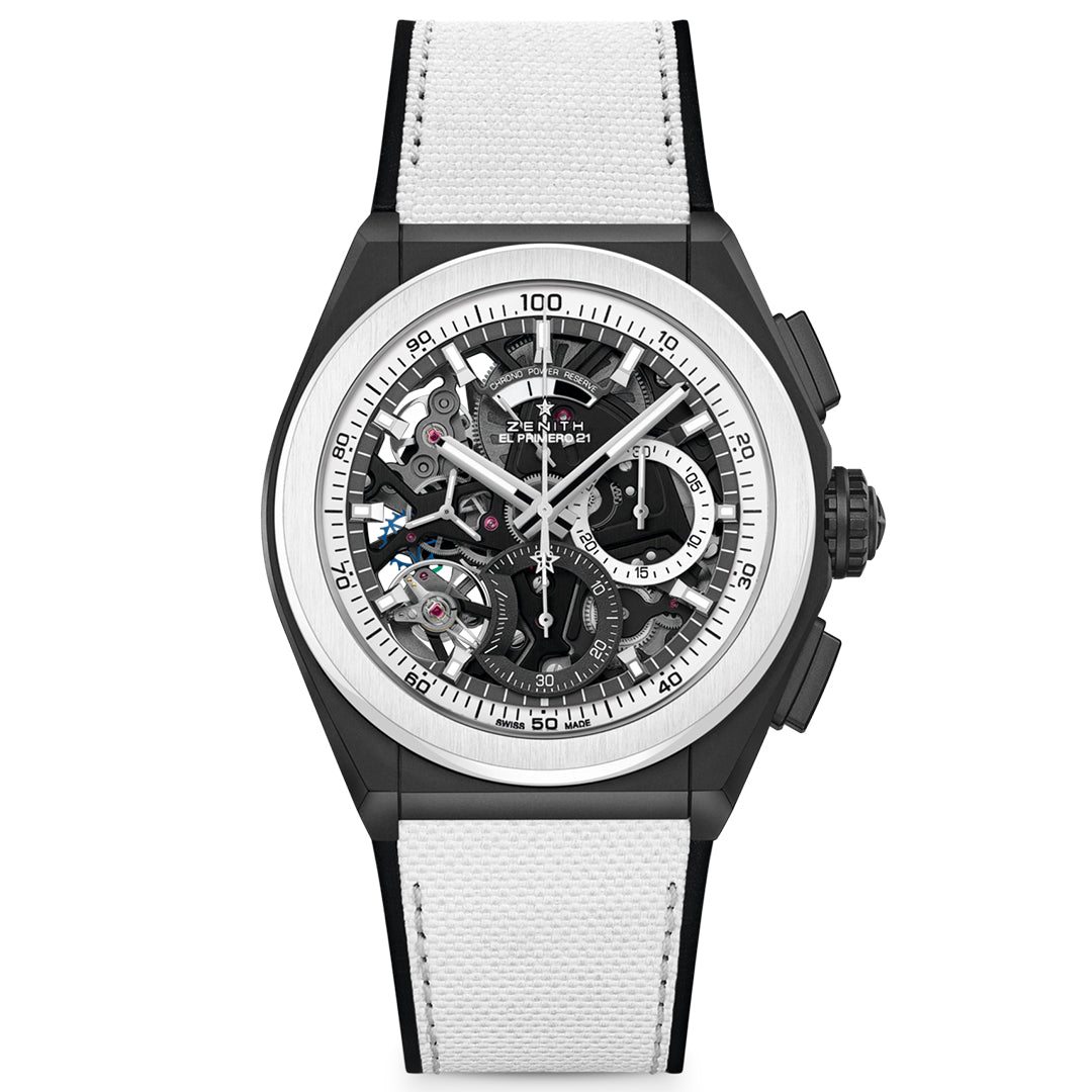 The ZENITH Defy El Primero 21 features a skeleton dial showcasing precise mechanics in a sleek ceramic case. It sports a black-and-white color scheme with a white strap and black accents, with sleek hands and markers that emphasize its precision.