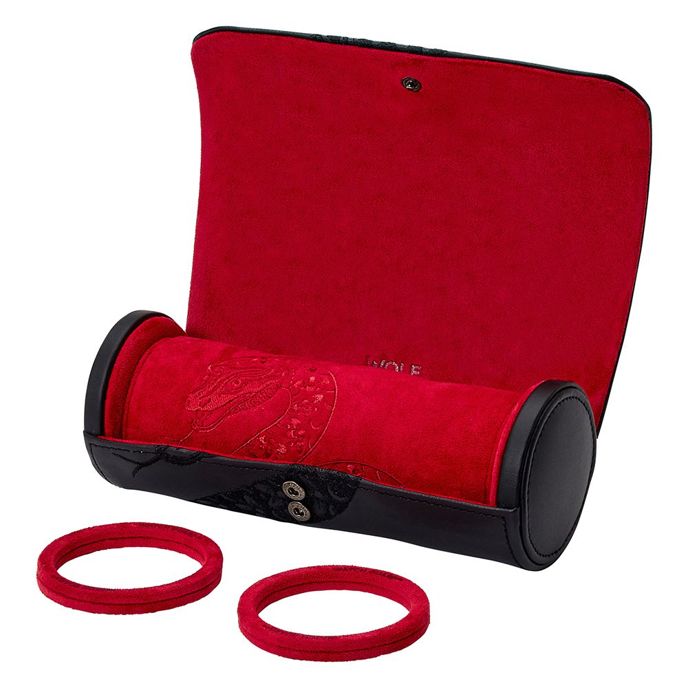 The WOLF 1834 Lunar Triple Watch Roll by WOLF, shown open with its red velvet interior and black ends, sits beside two matching red velvet bangles—an elegant accessory inspired by Chinese New Year.
