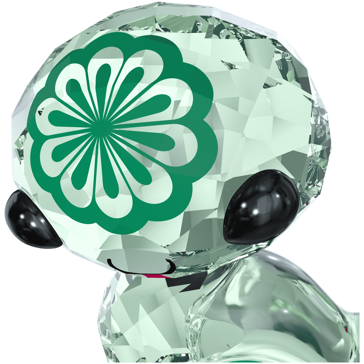 A shiny, transparent character from Swarovski named “Zodiac - Hebi the Snake,” featuring black eyes, a smiling mouth, and a green, flower-like emblem on its head—reminiscent of the playful charm found in Swarovski’s signature Zodiac figurines.