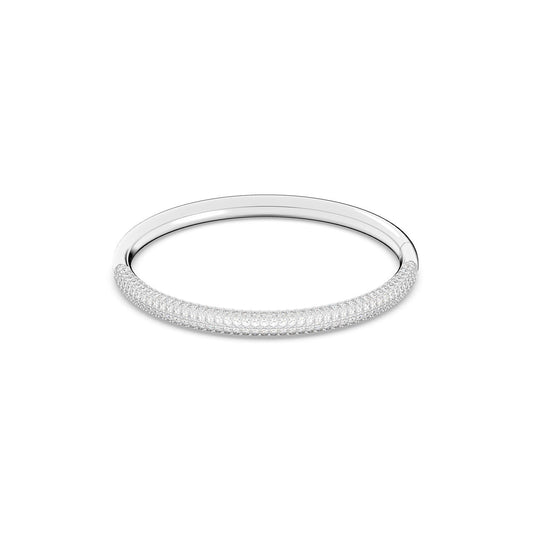 The Swarovski Stainless Steel Stone Bangle is a chic silver accessory featuring a textured, sparkling design on its exterior, elegantly displayed against a plain white background. This crystal pavé accent from Swarovski gives the bangle an on-trend appearance, making it a versatile choice for any occasion.