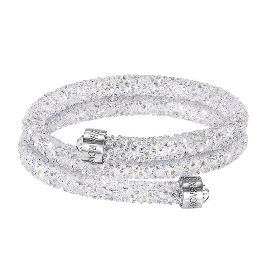 A dazzling Swarovski Crystal Dust Double Bangle featuring clear accents of Swarovski Crystal Rock, complemented by silver-toned magnetic clasps and crafted in an elegant twisted design.