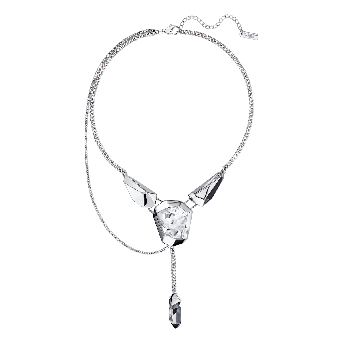 Introducing the Swarovski Necklace from the Other Style collection, featuring three geometric crystals—one at the center and two on each side—beautifully connected by a sleek chain. A single dangling crystal pendant elegantly hangs below the centerpiece. Presented against a white background, this exquisite necklace is available at Raffi Jewellers, your premier destination for Swarovski Canada.
