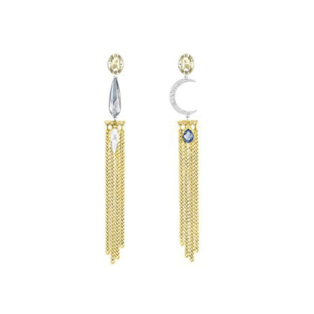The Swarovski Gipsy Pierced Drop Earrings exhibit a teal design accented with dangling tassels; one earring highlights a light blue tear-shaped gem, while the other features a crescent moon embellished with shimmering crystals. Delicate gold chains hang gracefully beneath each piece.