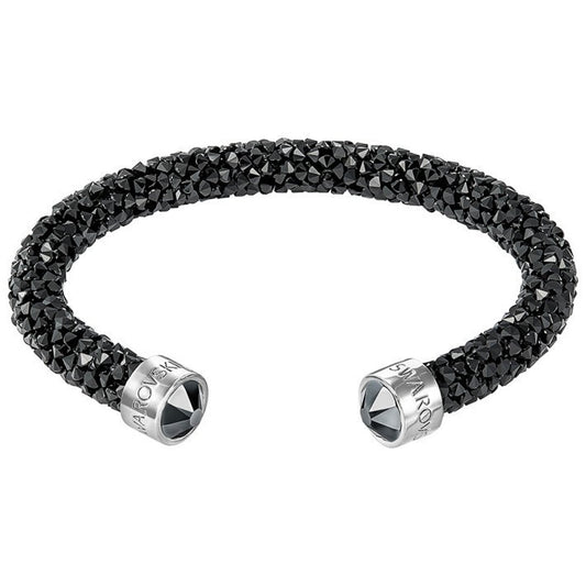 Discover the Swarovski Crystal Dust Cuff, a sleek and elegant black crystal-studded open bangle adorned with silver metal caps featuring engraved brand logos. This exquisite piece from Swarovski combines texture and shine with a touch of sparkling crystals.