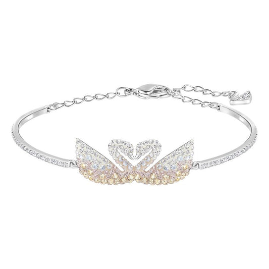 The Swarovski Iconic Swan Bangle features a central design of two wings forming a heart shape, adorned with Swarovski crystals that transition from clear to light gold. This bracelet includes an adjustable chain and a lobster clasp, drawing inspiration from Swarovski's iconic swan motif.