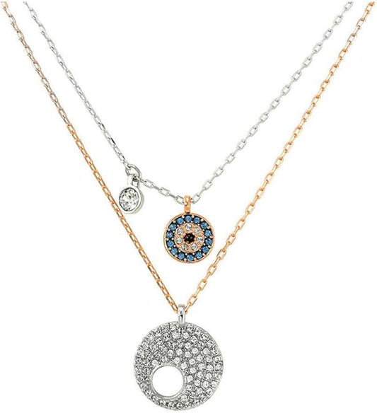 Explore the captivating Swarovski Evil Eye Necklace Pendant Set, offering a breathtaking combination of three exquisite chains: one highlighting a small round pendant with a clear gem, another featuring an Evil Eye Pendant encircled with blue and clear stones, and a third presenting a large round pendant embellished with numerous Swarovski crystals.