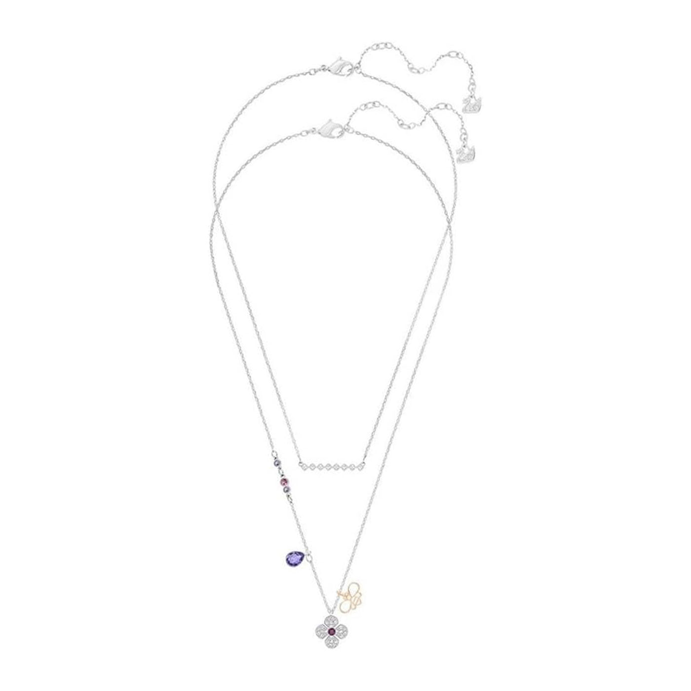 Introducing the Swarovski Clover Necklace Pendant by Swarovski, featuring three delicate chains. This exquisite piece showcases an array of sparkling charms, including a brilliant purple teardrop gem, a rhinestone-adorned flower pendant, and a small gold-colored infinity symbol. A shimmering addition to your jewelry collection.