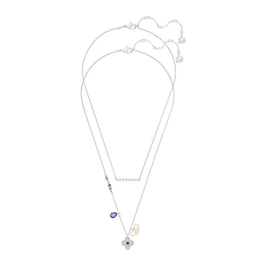 Introducing the Swarovski Clover Necklace Pendant by Swarovski, featuring three delicate chains. This exquisite piece showcases an array of sparkling charms, including a brilliant purple teardrop gem, a rhinestone-adorned flower pendant, and a small gold-colored infinity symbol. A shimmering addition to your jewelry collection.