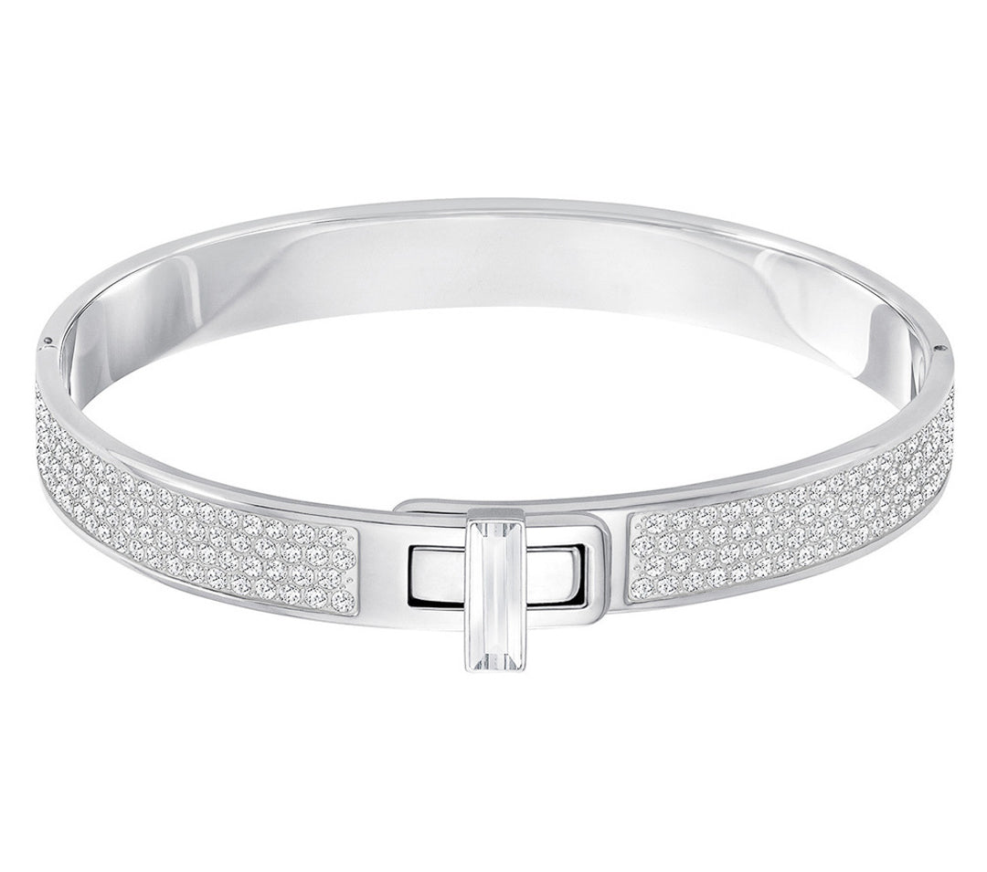The Swarovski Gave Bangle is a sophisticated piece with a silver band embellished with shimmering crystals and a rectangular clasp, elegantly highlighted against a crisp white background.