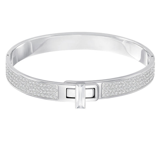 The Swarovski Gave Bangle is a sophisticated piece with a silver band embellished with shimmering crystals and a rectangular clasp, elegantly highlighted against a crisp white background.