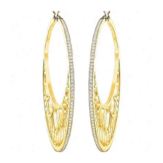 The Swarovski Georgette Hoop Earrings are an elegant and elongated pair of gold hoops designed with intricate cut-out patterns and adorned with a row of small, sparkling Swarovski crystals along the outer edge.