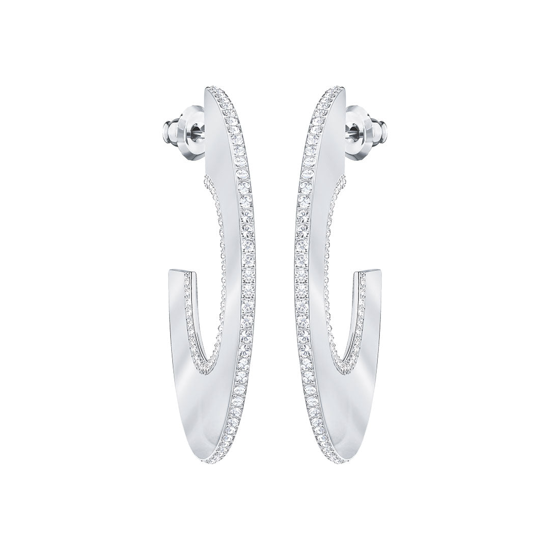 Presenting the Swarovski Gelane Hoop Earrings: a stunning pair of elegant silver hoops adorned with small, sparkling white crystals along the outer edges. These beautifully designed earrings feature a slight twist, offering a modern and sophisticated appearance. They are showcased against a pristine white backdrop to highlight their exquisite craftsmanship.