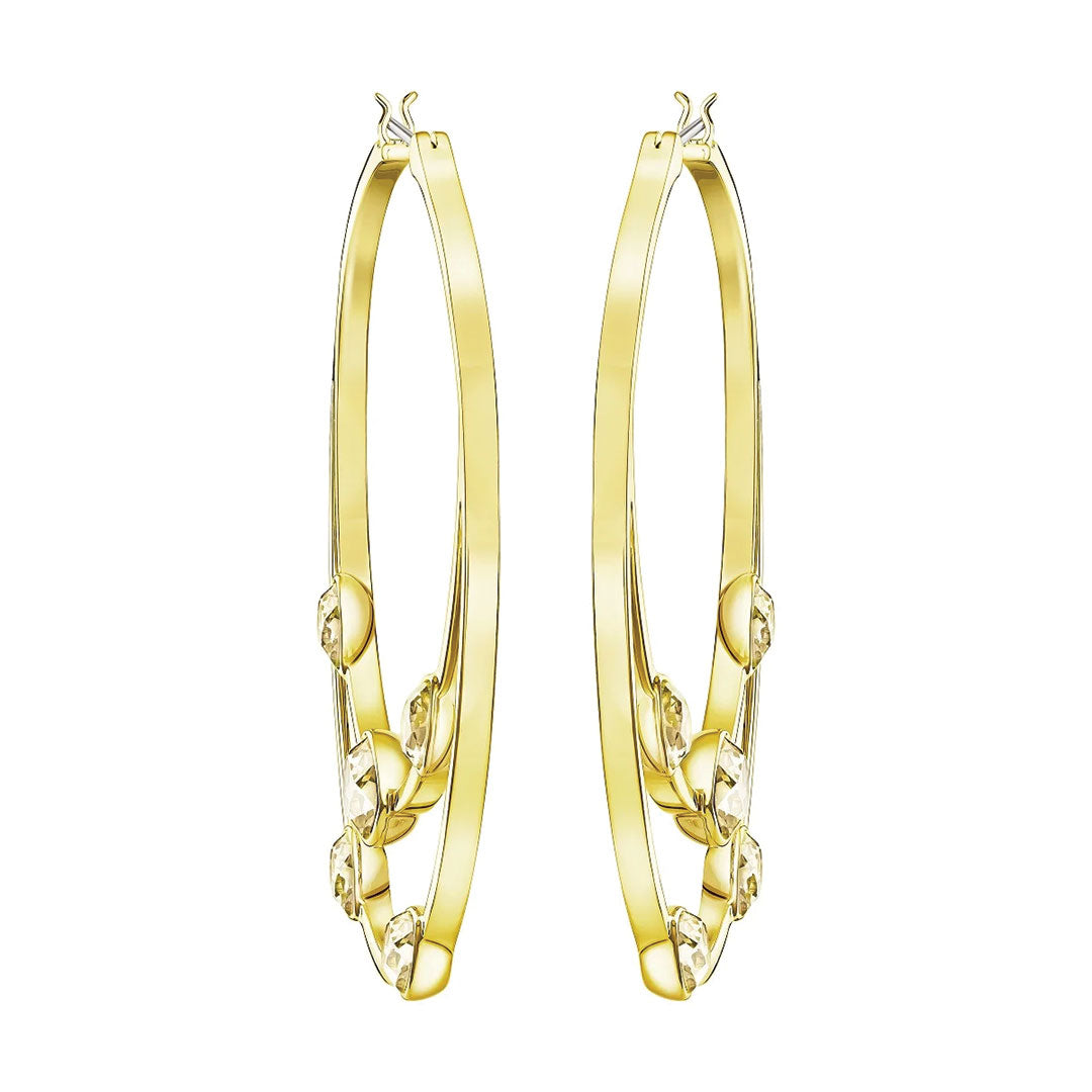 A pair of Swarovski Gaze Hoop Earrings in a large size, featuring gold hoops embellished with decorative patterns and clasp closures at the top; these sparkling crystals add a touch of elegance reminiscent of the renowned Swarovski brand.