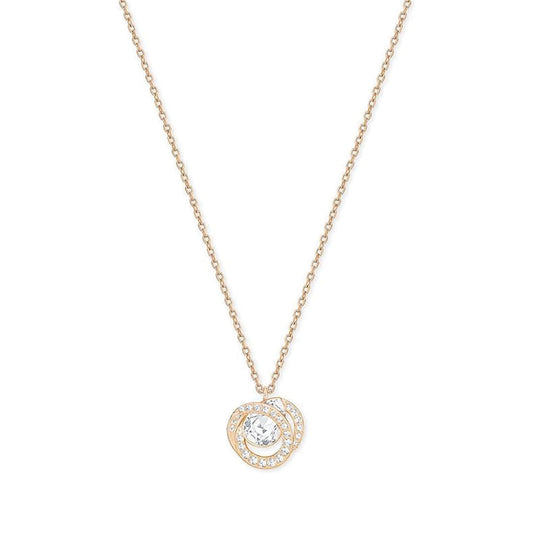 The Swarovski Generation Necklace Pendant by Swarovski is a refined rose gold-plated piece featuring a round centerpiece adorned with a clear central gemstone. This striking pendant is surrounded by a dazzling halo of smaller stones, and it hangs from a simple yet elegant chain that beautifully accentuates the intricate design.