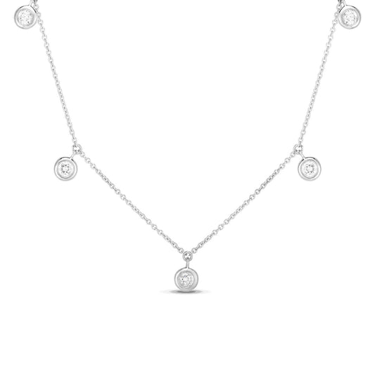 The Roberto Coin Diamonds By The Inch 18K White Gold Dangling Five Station Necklace showcases an elegant and simple design. Featuring a series of small round pendants with sparkling gems evenly spaced along the chain, this necklace highlights the shimmer of its diamonds against the delicate white gold backdrop.