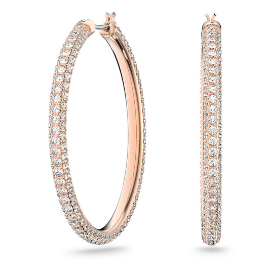 Introducing the Swarovski Rose Gold Stone Hoop Earrings by Swarovski, featuring an elegant design with rose gold plating and encrusted with shimmering Swarovski stones. One earring is displayed facing forward, while the other is turned to the side.