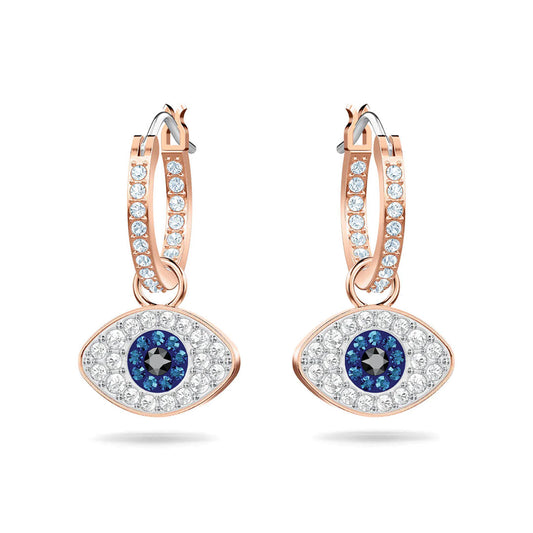 The Swarovski Evil Eye Hoop Earrings by Swarovski feature rose gold pavé hoops adorned with small clear stones, complemented by eye-shaped pendants. Each pendant showcases a central black stone encircled by blue and clear stones, forming the iconic protective evil eye symbol.