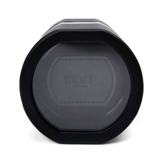 The WOLF 1834 The Rocket Travel Watch Winder is a round, black device with a transparent front showcasing the "WOLF" brand name. Its sleek cylindrical design offers bi-directional rotation and includes a USB Type-C charging port, making it ideal for securely holding and maintaining a single watch on the go.