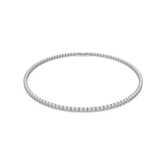 Introducing the Swarovski Round Cut Tennis Deluxe Necklace, a dazzling piece adorned with small, round zirconia stones arranged in an unbroken line on a rhodium-plated silver or white gold chain. This exquisite necklace forms a complete circle and secures with a clasp at the back.