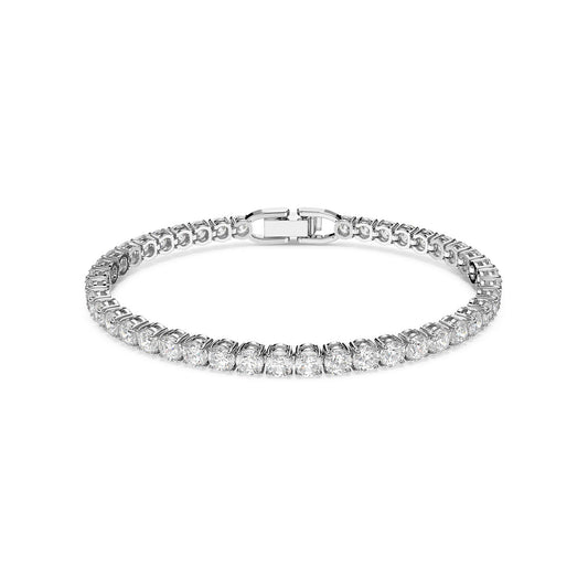 The Swarovski Round Cut Tennis Deluxe Bracelet by Swarovski is rhodium-plated and features a symmetrical line of round, sparkling zirconia. Its secure clasp ensures a safe fit, while the bracelet is elegantly showcased against a plain white background, highlighting its luxurious design.