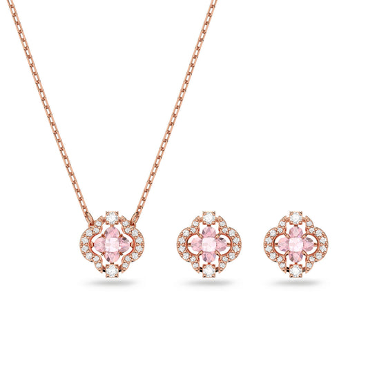 The Swarovski Sparkling Dance Jewellery Set by Swarovski includes a necklace and earring pair in rose-gold tone plating, embellished with pink clover stones and surrounded by small crystals. The necklace features a simple chain, and the earrings reflect the pendant's graceful floral design.