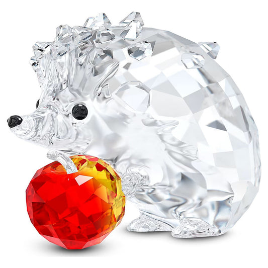 The Swarovski Hedgehog with Apple Home Décor piece from Swarovski features a dazzling, faceted texture and exquisite detailing, complete with black eyes and nose. A vibrant red and orange crystal apple adds a playful element to this expertly crafted masterpiece.