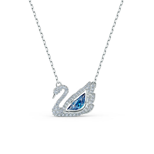 The Swarovski Dancing Swan Necklace Pendant, by the renowned brand Swarovski, features a swan-shaped pendant embellished with small clear gemstones and highlighted by a large blue gemstone at its center. This exquisite piece of jewelry shimmers beautifully, with its dancing stone mechanism offering an enchanting effect against the white background.