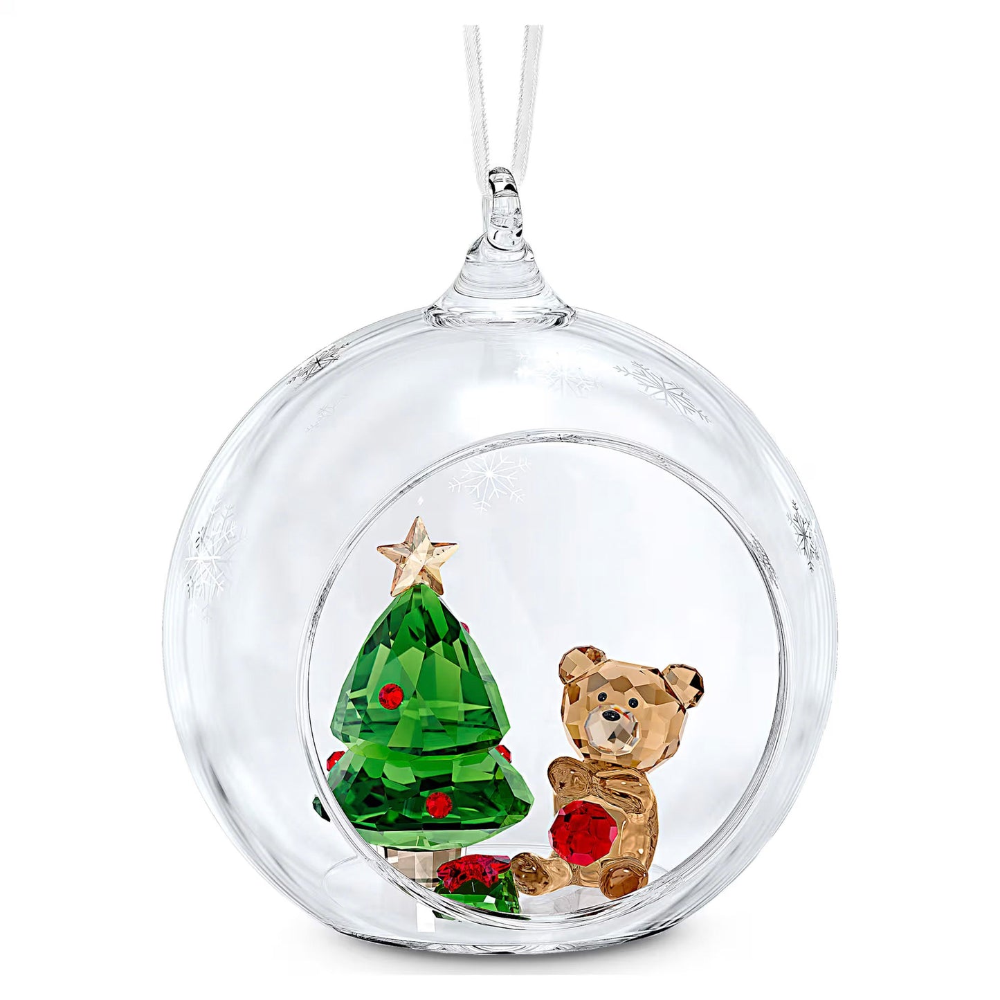 The Swarovski Joyful Ball Christmas Scene Ornament, crafted by Swarovski, exquisitely captures a festive tree scene within a clear glass design. It showcases a small green crystal Christmas tree crowned with a star and paired with a golden bear holding a red gift, all surrounded by delicate snowflake patterns on its exterior.