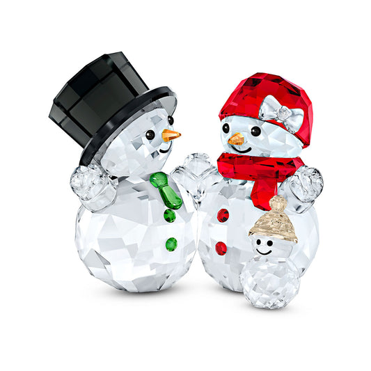 The Swarovski Snowman Family Home Décor from Swarovski showcases two joyful snowmen crafted in sparkling clear crystal; one wears a black hat and green scarf, the other dons a red hat and scarf. Completing this festive collection is a small crystal snowman adorned with colorful accents.