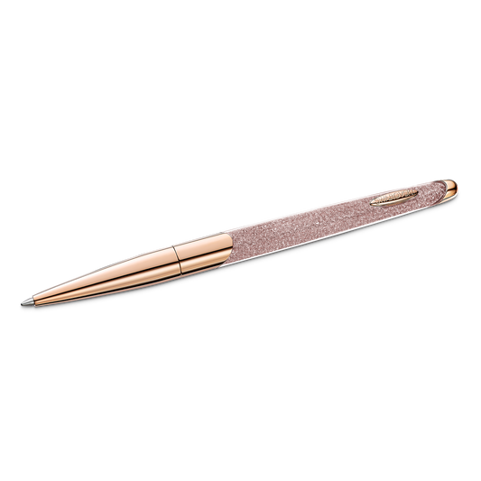 A sophisticated ballpoint pen from Swarovski, featuring a rose gold tone and rose gold-tone plating, with a textured grip against a black background. Its modern and elegant design boasts shiny metallic finishes and is embellished with clear Swarovski Crystalline Nova crystals, adding brilliance to its refined appearance.